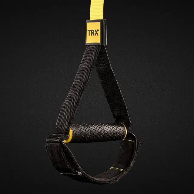 TRX Pro4 Suspension Trainer – yellow straps hanging vertically illustrating length-adjustment buckles and padded grips