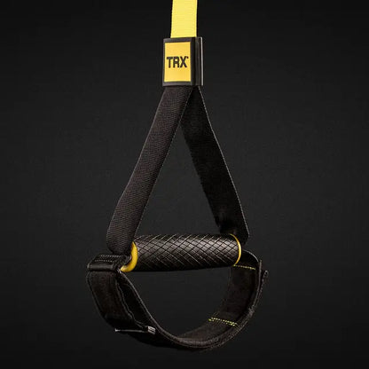 TRX Pro4 Suspension Trainer – yellow straps hanging vertically illustrating length-adjustment buckles and padded grips