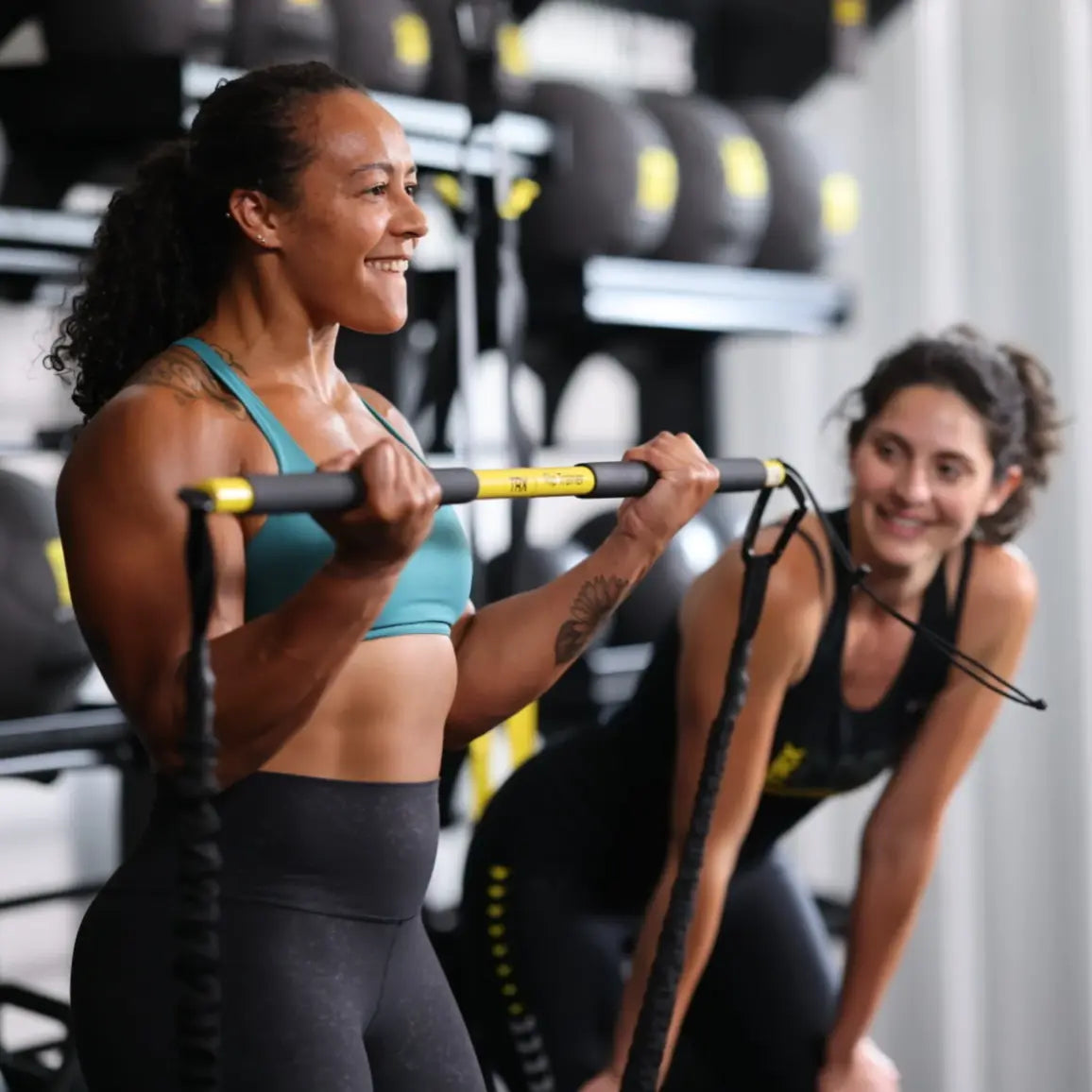 TRX HexGrip Weight Vest – lifestyle shot of athlete wearing vest during dynamic core rotation exercise