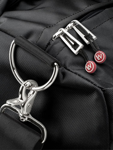 Close-up of a black bag with zip pulls and a metal keyring.