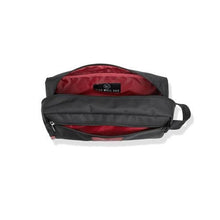 Open black toiletry bag with red interior lining.