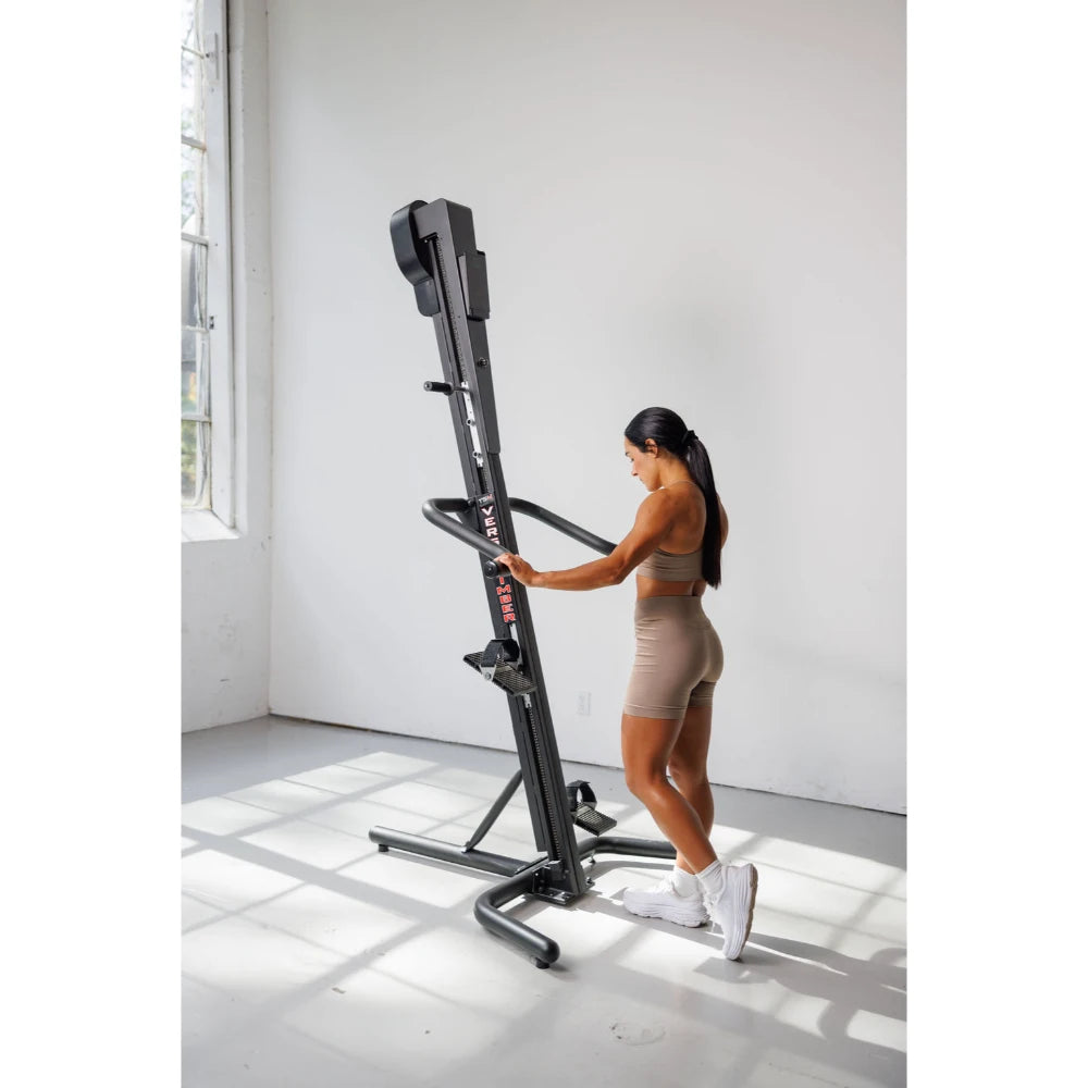 VersaClimber TS Magnetic – user checking workout stats on HD touchscreen mid-session