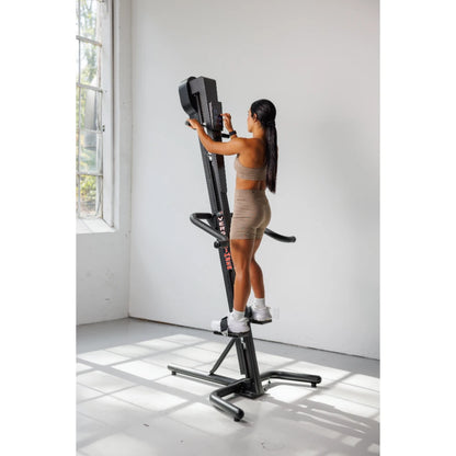 VersaClimber TS Magnetic – full-height shot of climber against gym mirror wall highlighting slim profile