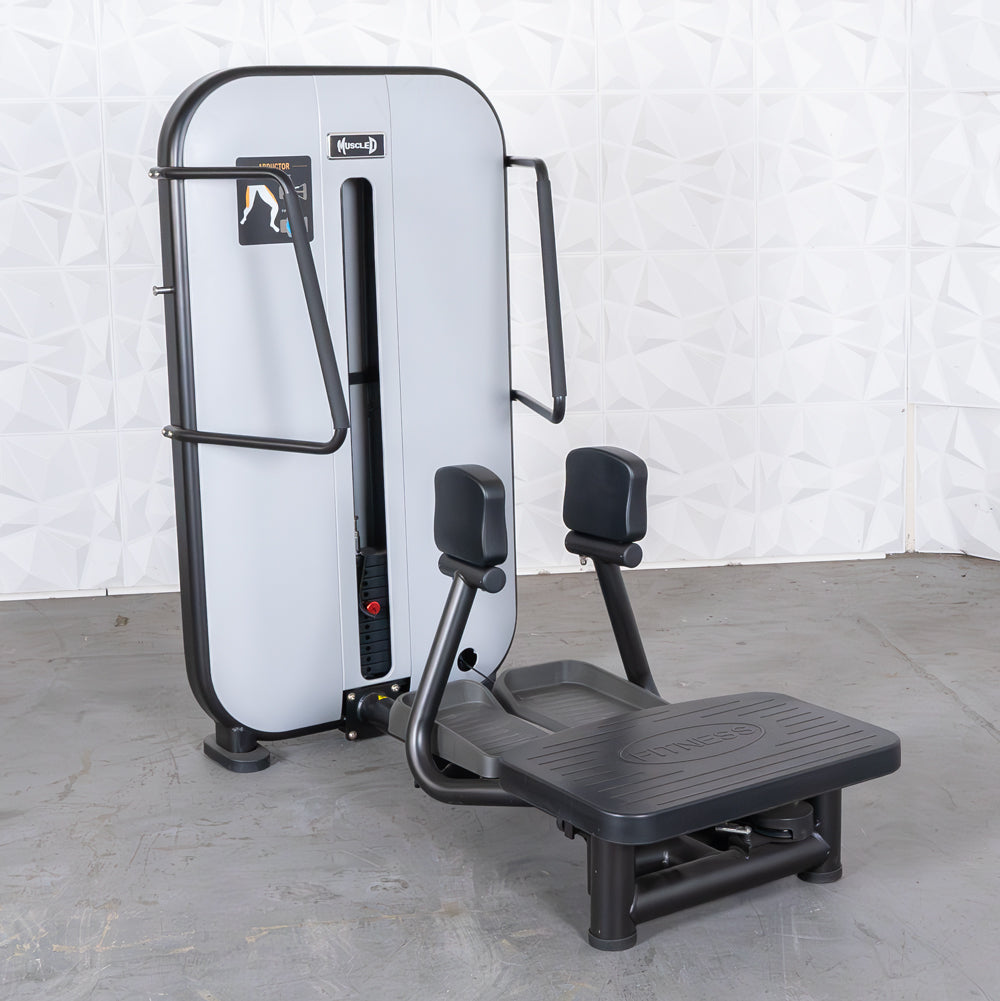 Standing abductor/adduction gym machine with leg pads and platform.