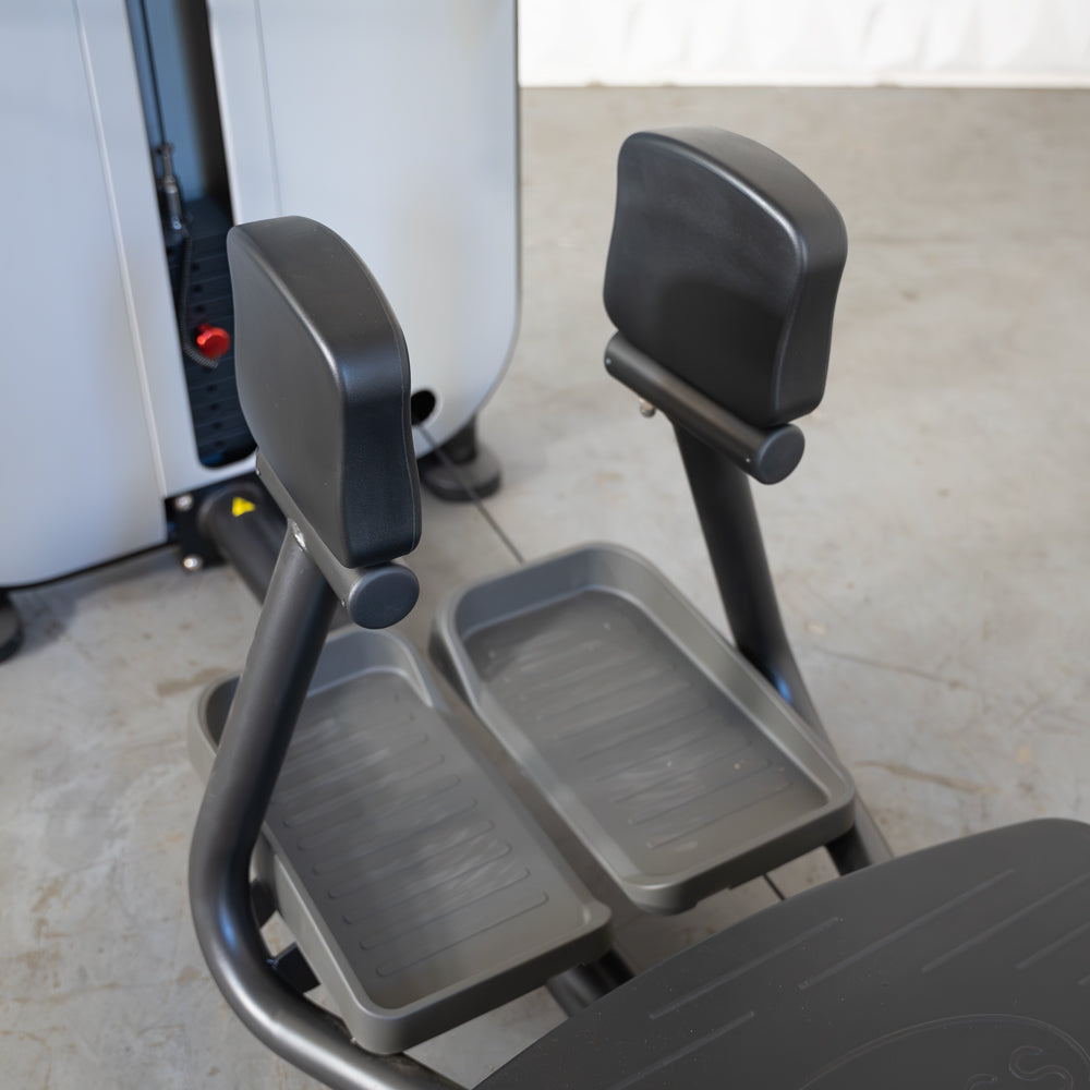 Standing abductor exercise machine with dual foot platforms.