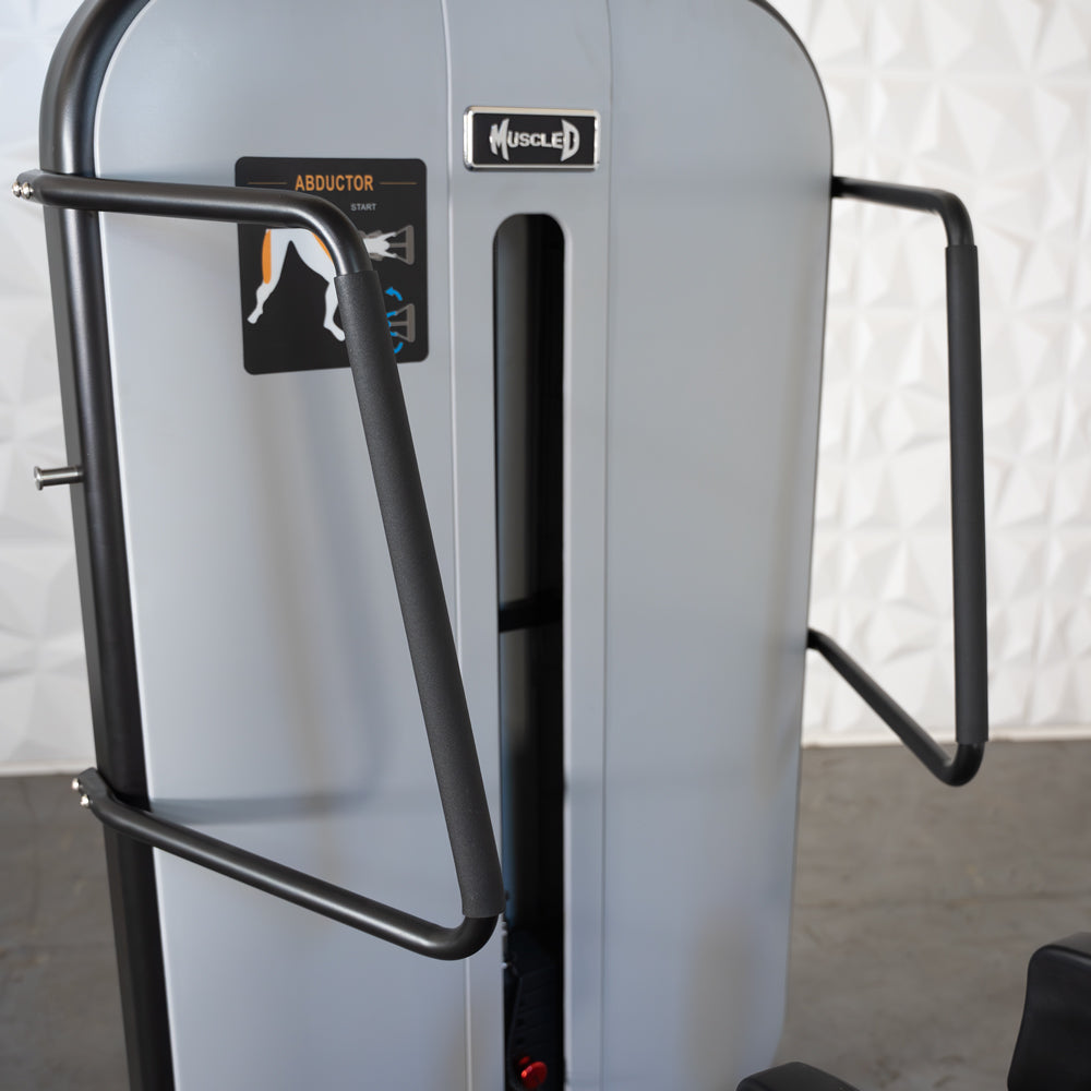 Standing abductor exercise machine with padded handles.