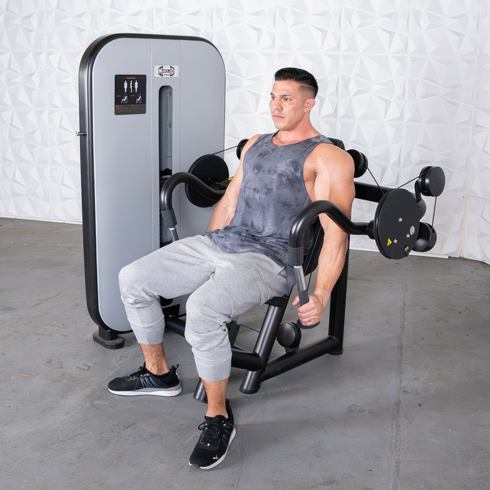 Man performing triceps extension on a gym machine.