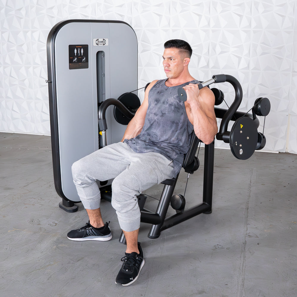 Man using a triceps extension machine at the gym.