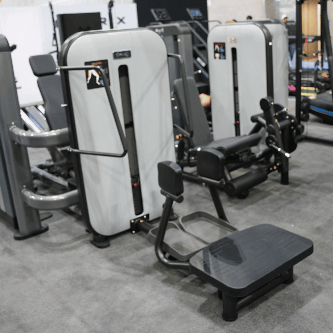 Standing abductor gym machine with padded leg supports and weight stack.