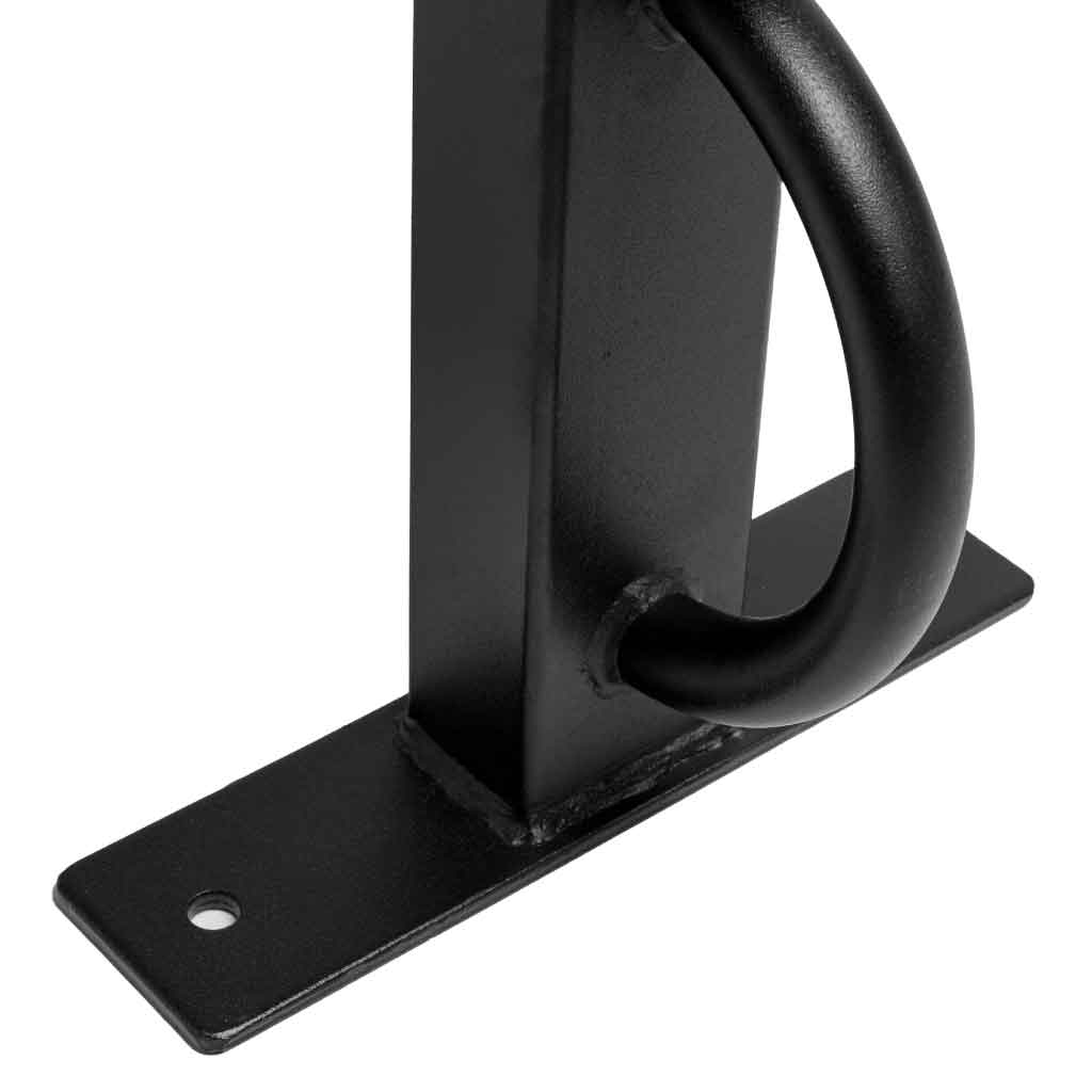 Close-up of black metal bench frame corner with curved foot brace on base plate.