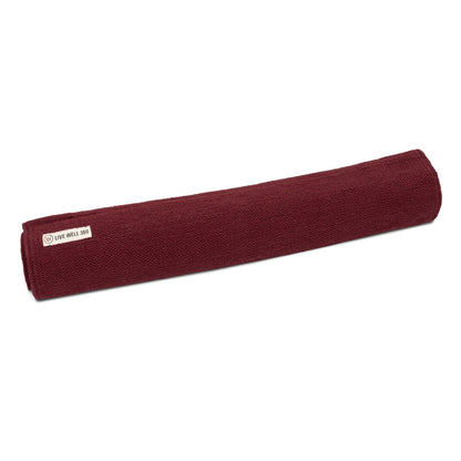 Maroon rolled yoga mat towel with a Live Well 360 label.