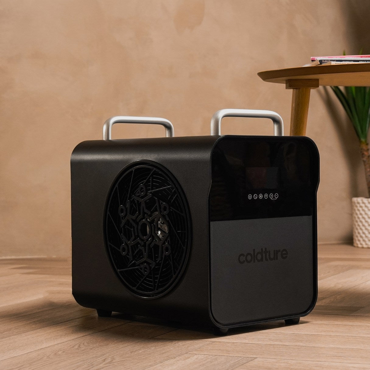 Coldture Water Chiller Pro, a sleek black portable cooling unit with a fan and digital display, placed on a wooden floor in a modern setting.