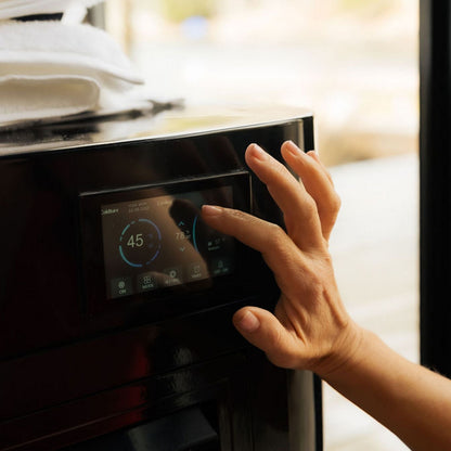 A hand interacting with the touchscreen display of the Coldture Pro Plunge, showing temperature settings of 45°F and 78°F.