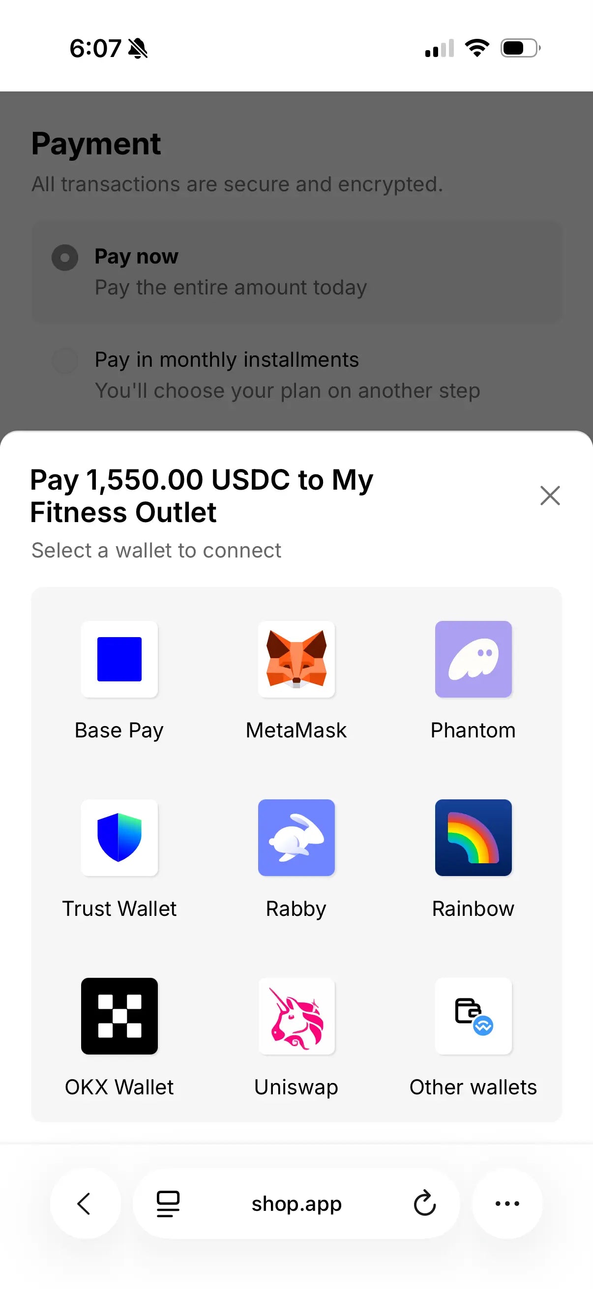 Mobile payment interface displaying a crypto checkout screen for "My Fitness Outlet" requesting 1,550.00 USDC, with nine wallet options including Base Pay, MetaMask, Phantom, Trust Wallet, Rabby, Rainbow, OKX Wallet, Uniswap, and Other wallets dis...