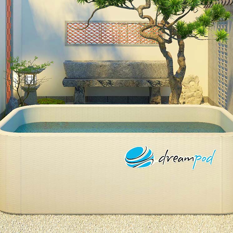 A serene outdoor setting featuring a Dreampod Home Float Flex, a rectangular floating pool with clear water, surrounded by stone benches, greenery, and a decorative wall.