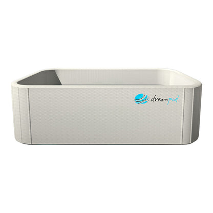 Dreampod Home Float Flex, a modern, rectangular floatation pod in a light color with a textured surface and the Dreampod logo.