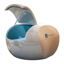Dreampod Home Float Plus, a modern floating therapy pod with a sleek design and an open lid, showcasing a tranquil blue interior filled with water.