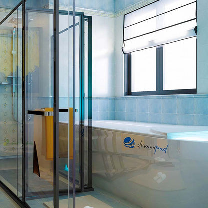 A modern bathroom featuring a glass shower enclosure and a Dreampod Home Float Pro bathtub with a sleek design and the Dreampod logo visible.
