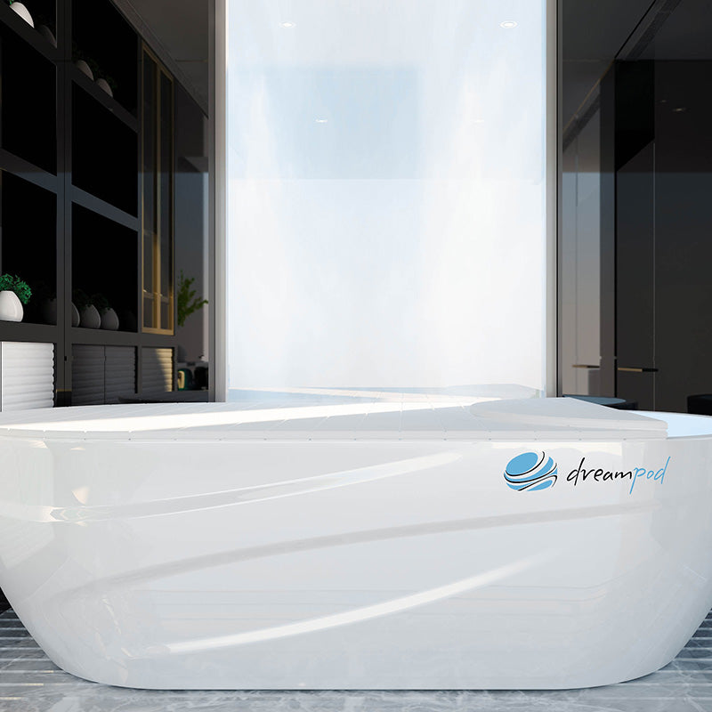 Dreampod Home Float Pro, a sleek white floatation pod, showcased in a modern interior setting with minimalistic decor.