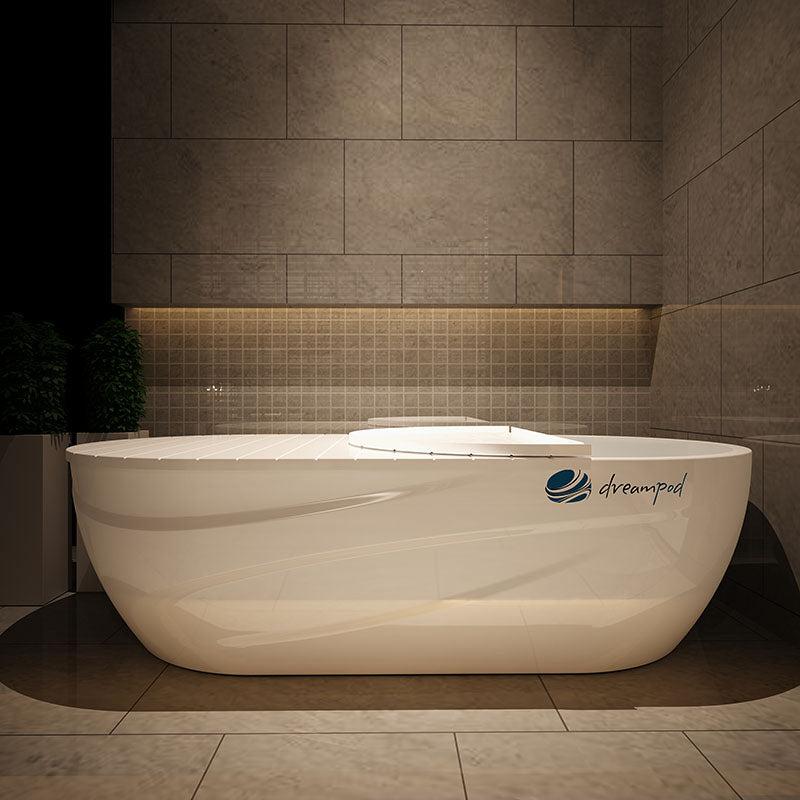 Dreampod Home Float Pro in a modern bathroom setting with stone walls and soft lighting.