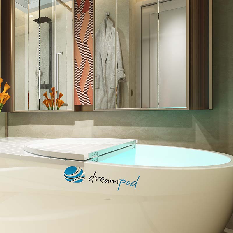 Dreampod Home Float Pro in a modern bathroom setting with a sleek design, featuring a floating tub, mirrors, and decorative elements.