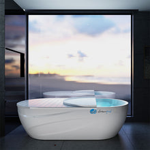 Dreampod Home Float Pro, a sleek white floatation pod with a minimalist design, situated in a modern room with large windows showcasing a serene outdoor view.