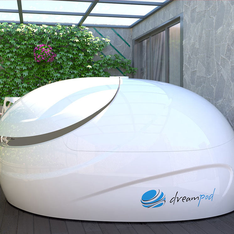 Dreampod Sport Float Pod positioned in a serene outdoor setting with greenery and a glass roof.
