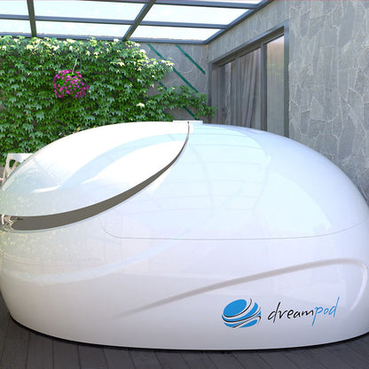 Dreampod Sport Float Pod positioned in a serene outdoor setting with greenery and a glass roof.