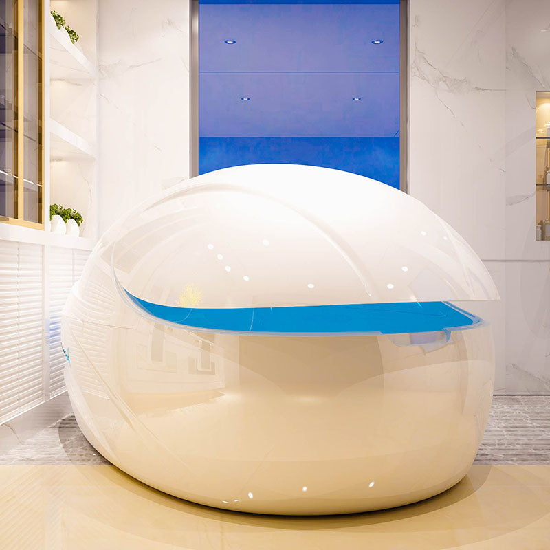 Interior view of a sleek, modern Dreampod V-Max Float Pod featuring a glossy white exterior with a blue accent, set in a stylish room.