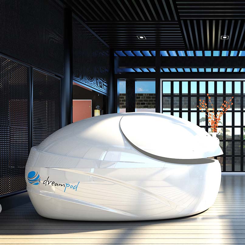 Dreampod V-Max Float Pod in a modern, stylish interior setting with large windows and decorative elements.