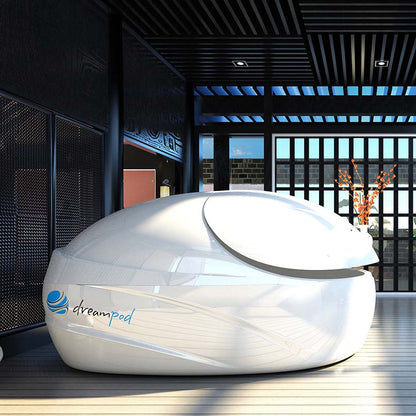 Dreampod V-Max Float Pod in a modern, stylish interior setting with large windows and decorative elements.