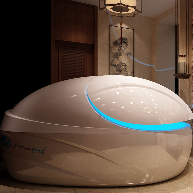 Dreampod V-Max Float Pod in a serene interior setting with soft lighting and decorative elements.