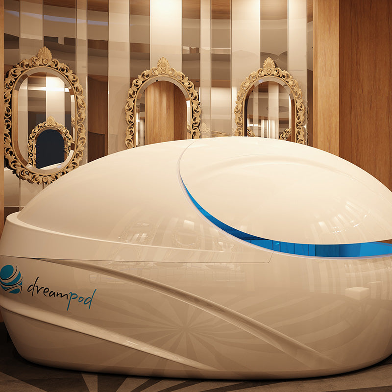 Dreampod V-Max Float Pod in a modern interior setting featuring ornate mirrors and wooden accents.