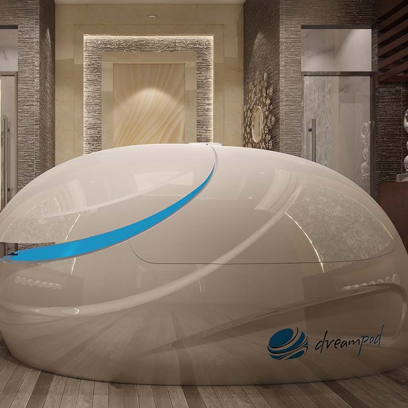 Dreampod V-Max Float Pod in a modern spa setting, featuring a sleek white design with a blue accent.