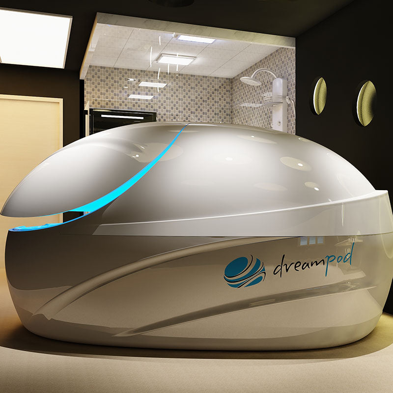 Dreampod V-Max Float Pod in a modern wellness space, showcasing its sleek design and blue accents.