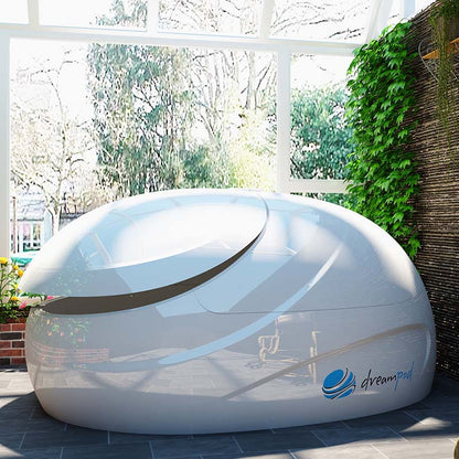Dreampod V2 Float Pod displayed in a bright, airy room surrounded by greenery and natural light.