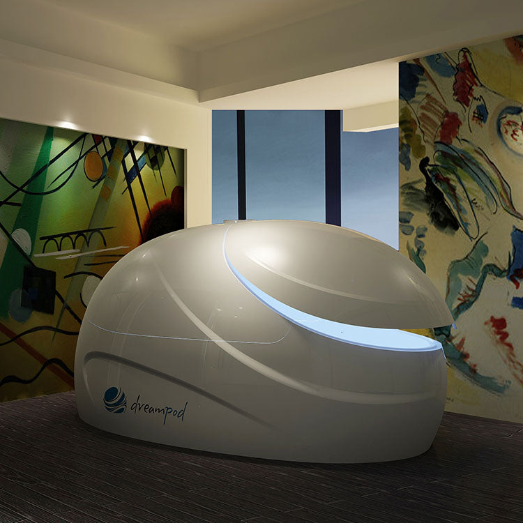 Dreampod V2 Float Pod in a modern room with abstract artwork on the walls.
