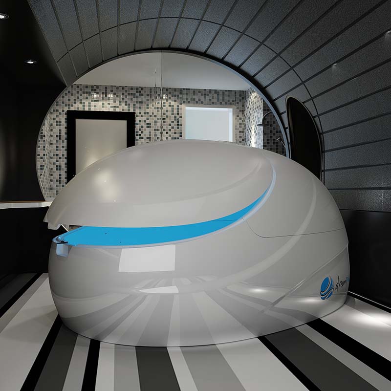 Dreampod V2 Float Pod in a modern, sleek interior space with black and white striped flooring and a mosaic wall.