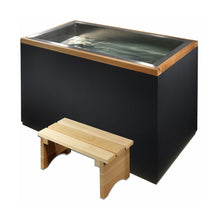 A modern, rectangular hot tub with a stainless steel interior and a wooden trim, accompanied by a small wooden bench.