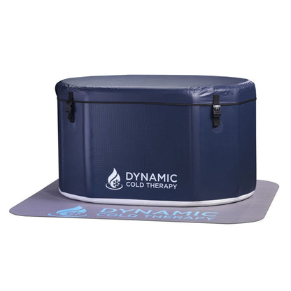 Dynamic Cold Therapy portable cold therapy unit, round design with a navy exterior and logo, placed on a matching mat.