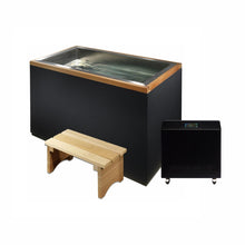 A black rectangular hot tub with a stainless steel top, accompanied by a wooden bench and a black control unit with a digital display.