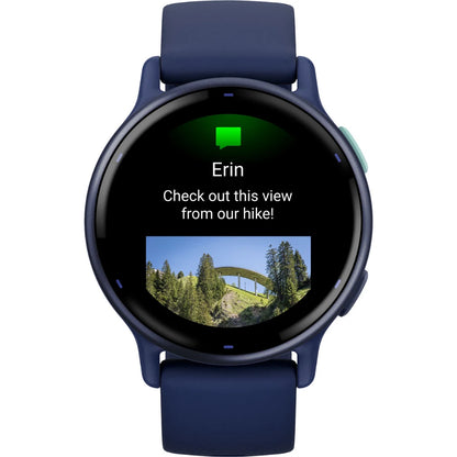 Smartwatch displaying a message from Erin with the text 'Check out this view from our hike!' and a small image of a scenic landscape featuring trees and a bridge.