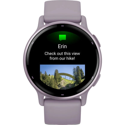 Smartwatch displaying a message from Erin with the text 'Check out this view from our hike!' along with a photo of a bridge surrounded by trees.