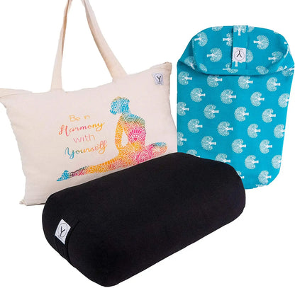 Yoga bolster set with cream canvas tote bag featuring colorful meditation pose illustration and "Be in harmony with yourself" text, turquoise zippered bolster cover with white leaf pattern, and black cylindrical cotton bolster.