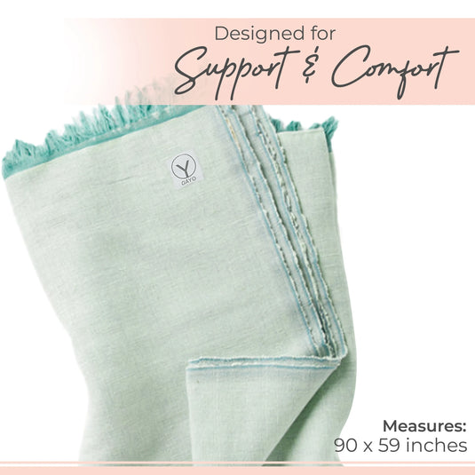 Mint green organic cotton yoga blanket with fringe trim along the top edge and decorative stitching on the side, measuring 90 x 59 inches.