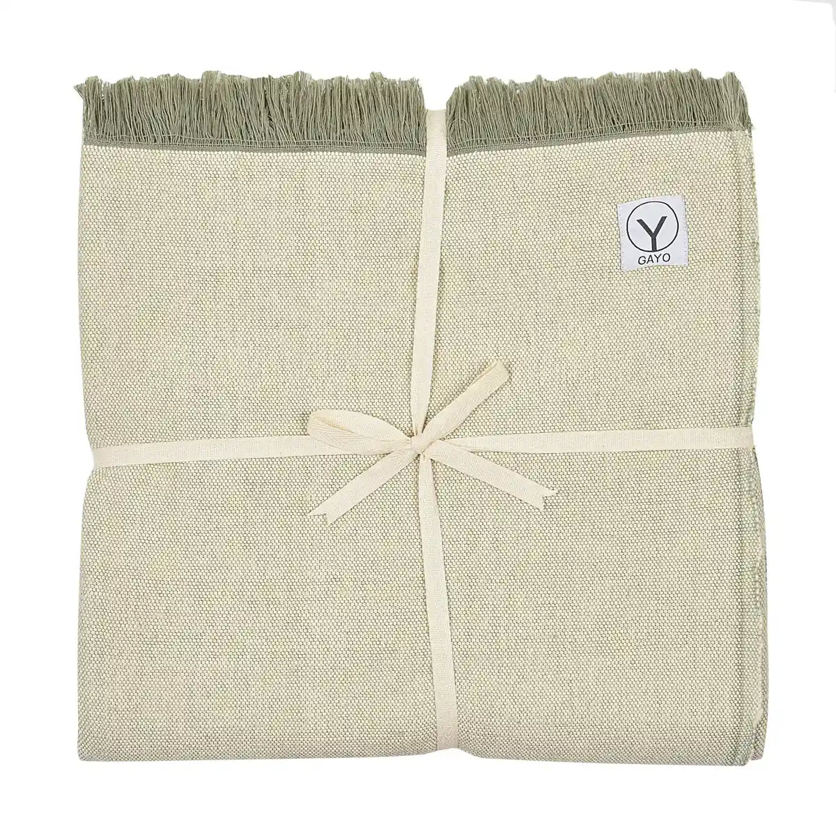 Folded organic cotton yoga blanket in cream and sage green with fringed edges and cream ribbon tie, Gayo brand label visible.