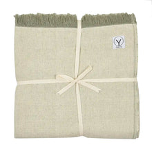 Folded organic cotton yoga blanket in cream and sage green with fringed edges and cream ribbon tie, Gayo brand label visible.