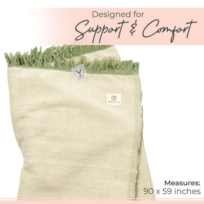Cream organic cotton yoga blanket with green fringe trim and branded label, measuring 90 x 59 inches.