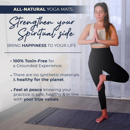 Woman performing a yoga pose on a dark gray organic cotton yoga mat in a bright studio space.