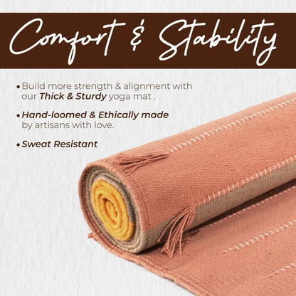 Rolled organic cotton yoga mat with terracotta outer fabric, yellow and beige inner layers, and decorative fringe trim visible on the end.